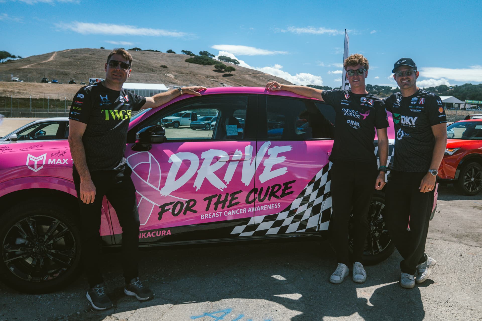 Max Taylor with fellow drivers beside the Drive for the Cure car at Laguna Seca